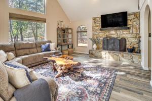 a living room with a couch and a stone wall at Deck and Game Room Lakeside Blue Jay Chalet Cabin in Lake of the Woods