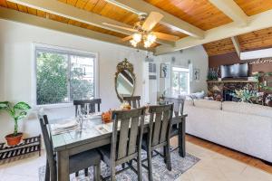 a dining room and living room with a table and chairs at Home with 2 Decks - 2 Mi to Lake Gregory Dog Park! in Crestline +25 photos