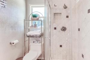 a bathroom with a toilet and a shower at Home with 2 Decks - 2 Mi to Lake Gregory Dog Park! in Crestline