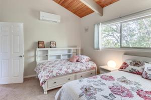 a bedroom with two beds and a window at Home with 2 Decks - 2 Mi to Lake Gregory Dog Park! in Crestline