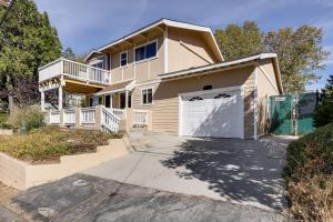a house with a garage and a fence at Home with 2 Decks - 2 Mi to Lake Gregory Dog Park! in Crestline