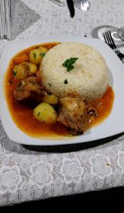 a plate of food with meat and potatoes and rice at POSADITA LOS ALAMOS Alojamiento de montaña estamos en San Isidro a 8km pasando Iruya lea atentamente la descripción in Iruya