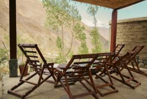 a group of chairs sitting on a porch with a mural at POSADITA LOS ALAMOS Alojamiento de montaña estamos en San Isidro a 8km pasando Iruya lea atentamente la descripción in Iruya