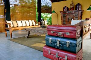 a stack of suitcases in a living room with a couch at Kumbukgaha Villa in Sigiriya