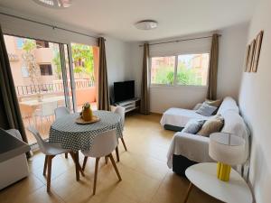 a living room with a couch and a bed and a table at Pool, Beach and Sun in Mar Menor Golf Resort in Torre-Pacheco