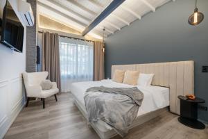 a bedroom with a bed and a chair and a window at Nago Hometel Boutique in Medellín +22 photos