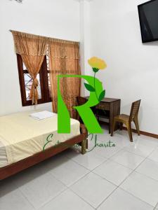 a bedroom with a bed and a desk and a tv at Estancia Charito Hospedaje in Iquitos