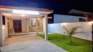 a patio of a house at night at Recanto do surf in Imbituba