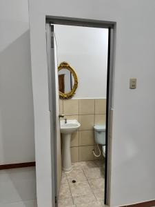 a bathroom with a sink and a toilet at Estancia Charito Hospedaje in Iquitos