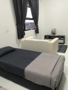 a white bedroom with a bed and a window at DyMaz Salam Homestay in Seri Iskandar