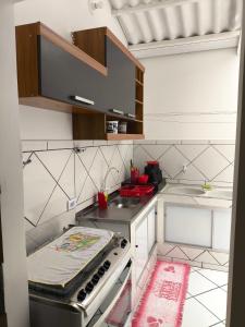 a kitchen with a stove and a counter top at Casas de Ferias Vovo Lene in São Mateus
