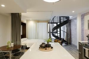 a bedroom with a bed and a staircase in a room at Abode Los Angeles - Downtown South Park in Los Angeles