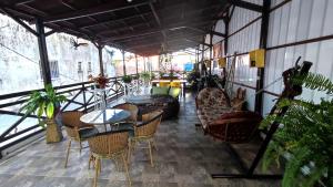 a patio with a table and chairs and plants at Pousada Solar Encanto do Marajó in Soure