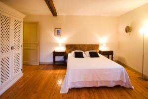 a bedroom with a bed and two end tables at B&B La Cerisaie in Francheleins