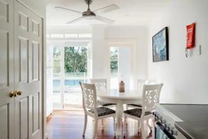 a dining room with a white table and chairs at Mountshannon in Ebenezer