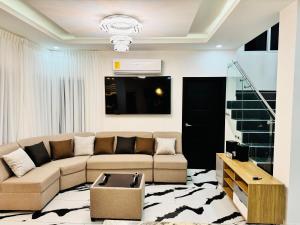 una sala de estar con un sofá y una mesa en Hermosa casa moderna con piscina, en San Pedro Sula