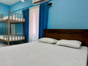 Uma cama ou camas num quarto em Havelock City Hostel, Colombo