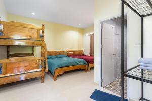 two beds in a room with a bunk bed at 99 Pool Villa in Jomtien Beach +55 photos