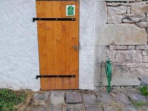 a wooden door on the side of a building at Gîte nature & confort rénové, Plateau des 1000 étangs - WIFI, parking - FR-1-583-302 in Saint-Bresson +27 photos
