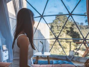 a woman sitting in front of a window at Baco Resort Nagano in Ueda +74 photos