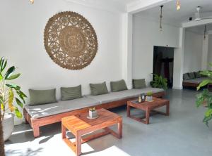 a living room with a couch and two tables at Drifter - Rooms & Food in Midigama