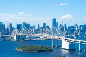 a bridge over the water in front of a city at HOSTEL LUND I -Oimachi- in Tokyo