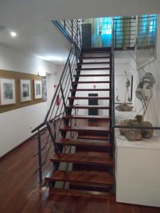 a spiral staircase in a room with wooden floors at Monsanto GeoHotel Escola in Monsanto