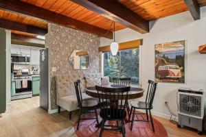 a kitchen and dining room with a table and chairs at Fleming Creek Hideaway, Next to Creek, Fire-Pit! in Lake Arrowhead +30 photos