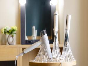a toothbrush holder with toothbrushes in a hotel room at Kansai Airport Washington Hotel in Izumi-Sano