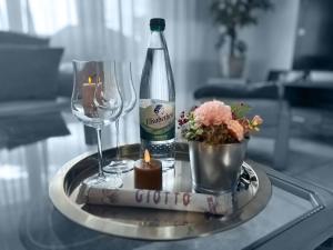 a table with a bottle and a wine glass and candle at Ferienwohnung GoodTimes in Hausen über Aar