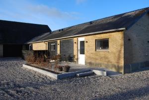 a brick building with a patio in front of it at Rind B&B in Herning