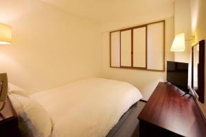 Letto o letti in una camera di Centurion Hotel Hamamatsu