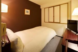 Letto o letti in una camera di Centurion Hotel Hamamatsu