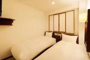 Letto o letti in una camera di Centurion Hotel Hamamatsu