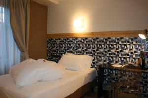 Postel nebo postele na pokoji v ubytování Hotel Orso Grigio
