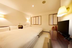 Letto o letti in una camera di Centurion Hotel Hamamatsu
