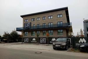 a car parked in front of a building at Hira Boarding Aparthotel in Dingolfing