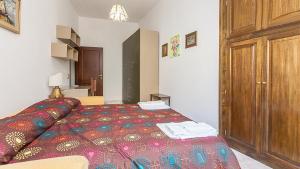 sypialnia z łóżkiem i drewnianą szafką w obiekcie Caterina One o One - Embassy Apartment w Rzymie