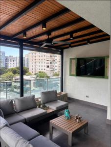 a living room with a couch and a table at Arpel 6 SantoDomingo CItySeaView in Santo Domingo