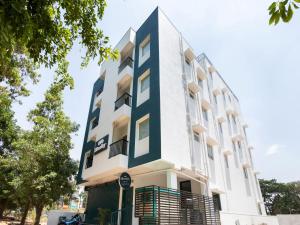 a building with a black and white facade at Hotel O Executive Stays Yelahanka New Town in Bengaluru