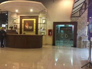 a lobby of a store with a counter in a building at Gorgeous & Classic 2BR at Braga City Walk Apartment By Travelio in Bandung +7 photos