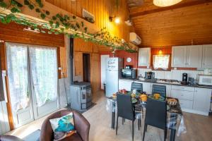 a kitchen with a table and chairs in a room at Chalet des 2 m 2/4 personnes in Antrenas