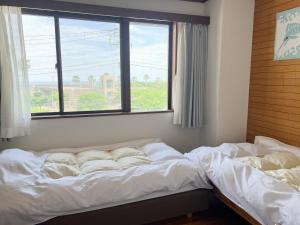 Een bed of bedden in een kamer bij Marina Bay Atami