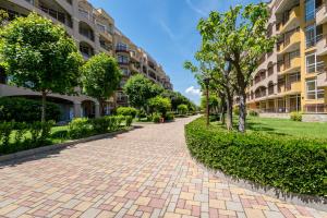 a brick driveway in front of a building at Midia Holiday Apartments in Aheloy