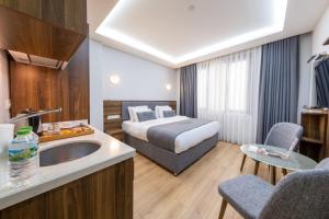 a hotel room with a bed and a sink at Beyzas Hotels & Suites in Istanbul +159 photos