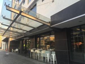 a restaurant with tables and chairs outside of a building at Weston Suites Hotel in Santo Domingo