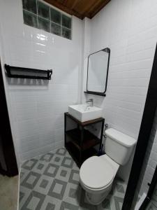 a bathroom with a white toilet and a sink at Villa Wat San in Luang Prabang +11 photos