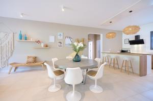 une cuisine et un salon avec une table et des chaises dans l'établissement Pointe aux Canonniers Beach Luxury Apartment, à Pointe aux Cannoniers