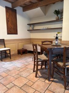 a dining room with a table and chairs and a bed at Rosso Mattone Mondovì in Mondovì