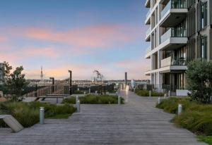a walkway next to a building with a building at Waterfront luxury living - Wynyard Quarter in Auckland
